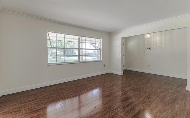 empty room with ornamental molding and dark hardwood / wood-style flooring