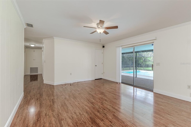 unfurnished room with ceiling fan, hardwood / wood-style flooring, and crown molding