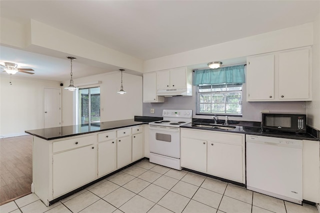 kitchen with white appliances, sink, kitchen peninsula, hanging light fixtures, and white cabinetry