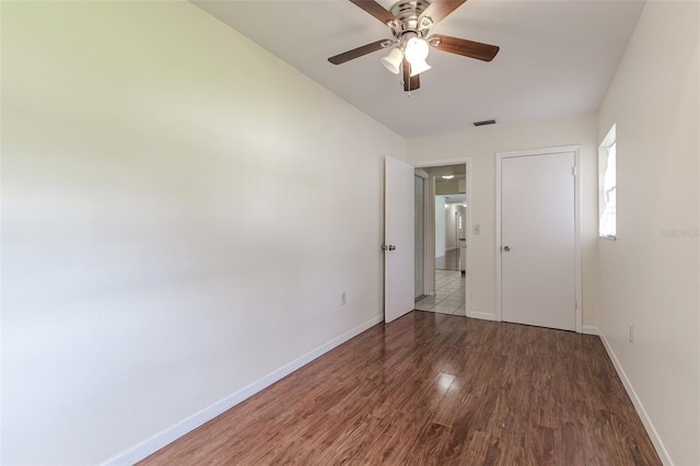 spare room with ceiling fan and dark hardwood / wood-style floors