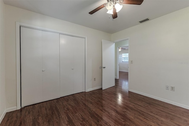 unfurnished bedroom featuring a closet, dark hardwood / wood-style floors, and ceiling fan