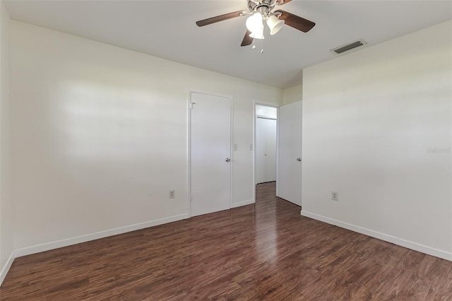 spare room with ceiling fan and dark hardwood / wood-style flooring