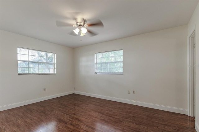 unfurnished room featuring dark wood-type flooring and ceiling fan