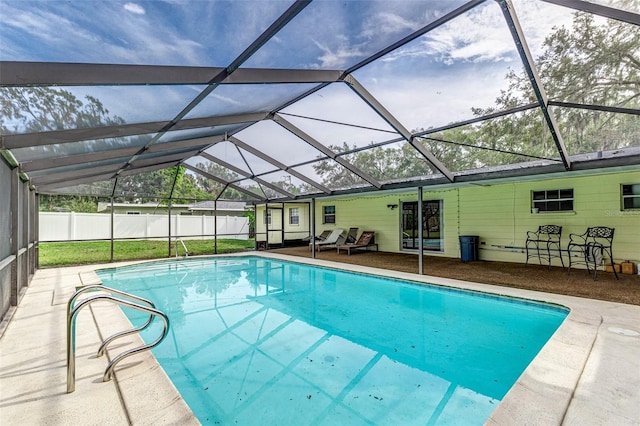 view of pool with a patio and glass enclosure