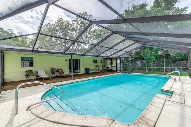 view of pool featuring a patio and glass enclosure