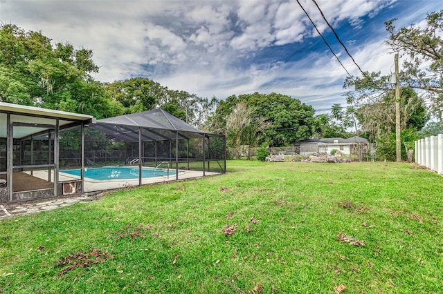 view of yard featuring a fenced in pool and a lanai