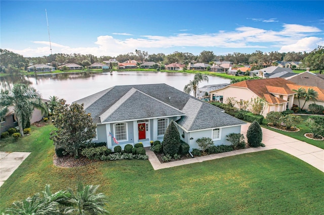 view of front of property with a front lawn and a water view