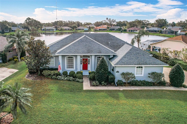 ranch-style house with a front yard and a water view