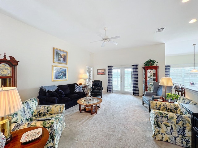 carpeted living room with french doors, a healthy amount of sunlight, and ceiling fan