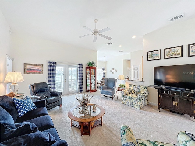 carpeted living room featuring french doors and ceiling fan