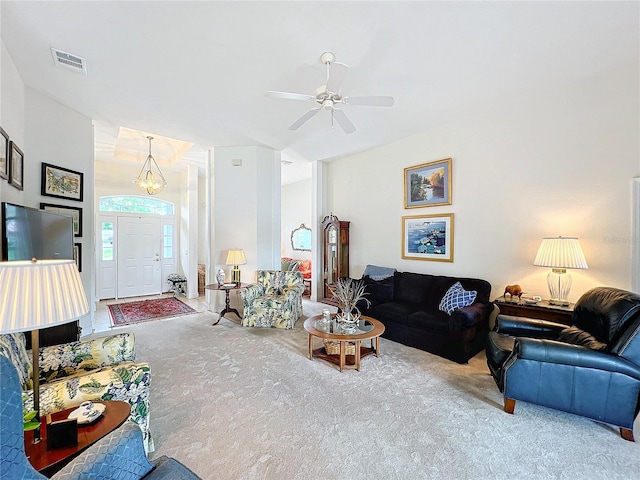 living room featuring carpet flooring and ceiling fan with notable chandelier