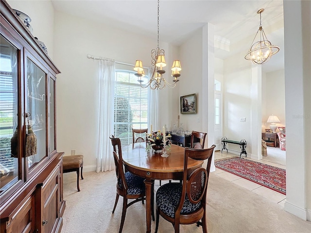 dining room featuring light colored carpet and an inviting chandelier