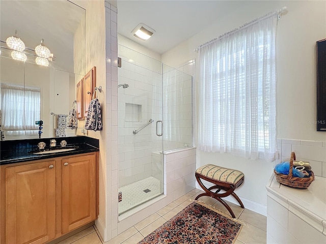 bathroom with vanity, walk in shower, and tile patterned flooring