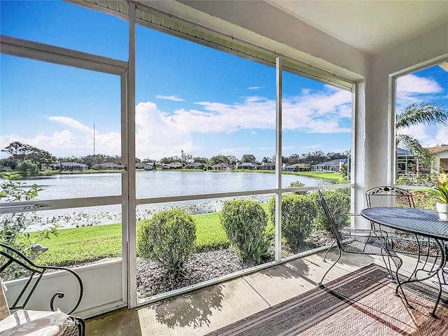 unfurnished sunroom with a water view