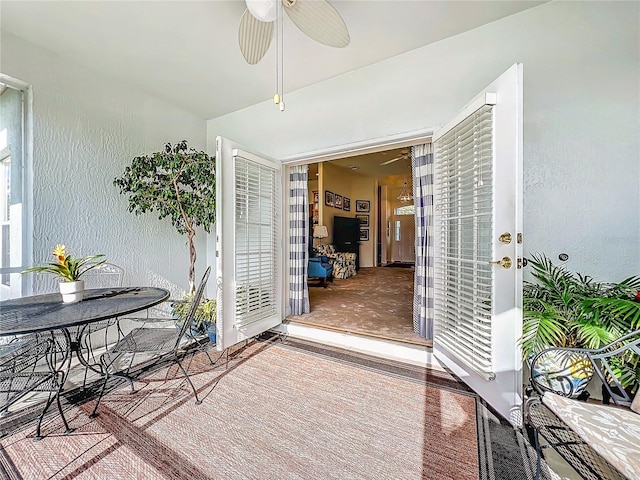 sunroom / solarium featuring ceiling fan