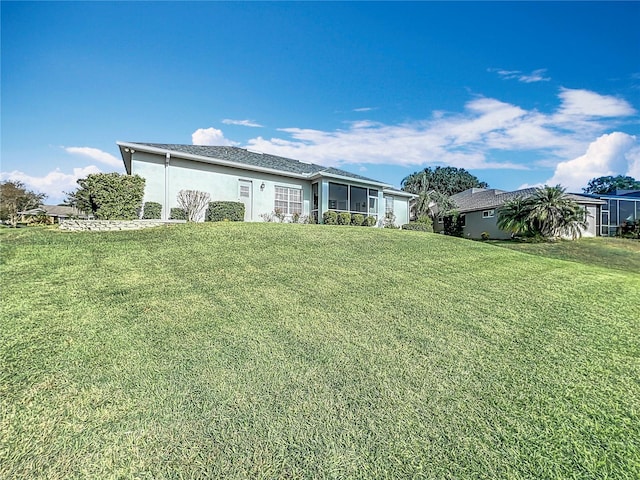 view of front of property with a sunroom and a front lawn