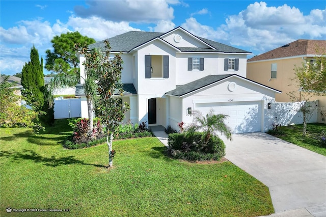 view of property with a front lawn and a garage