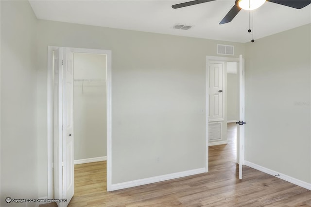 empty room featuring ceiling fan and light wood-type flooring