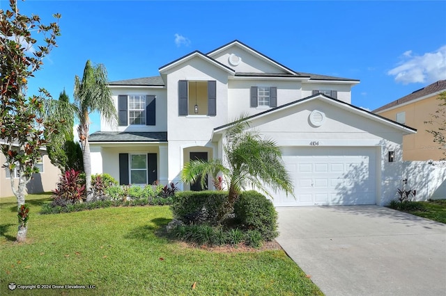 view of property with a front lawn and a garage