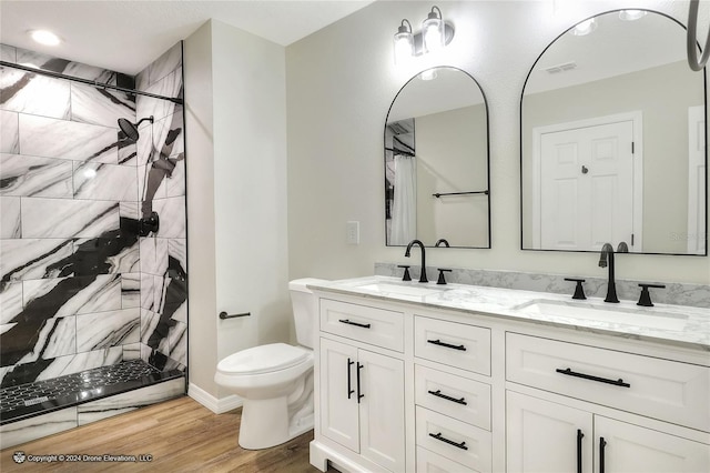 bathroom with walk in shower, hardwood / wood-style flooring, vanity, and toilet