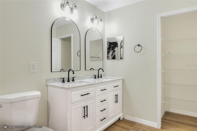 bathroom featuring hardwood / wood-style floors, vanity, and toilet