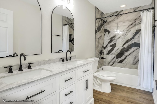 full bathroom with toilet, shower / bath combo with shower curtain, vanity, and hardwood / wood-style flooring