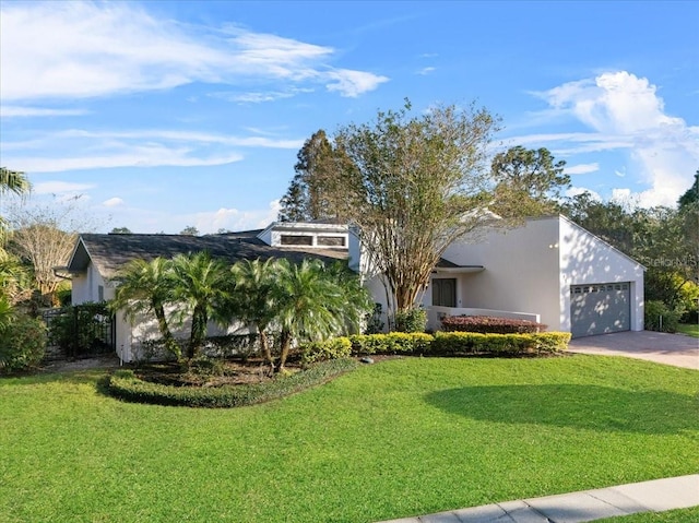 view of front of house with a garage and a front lawn