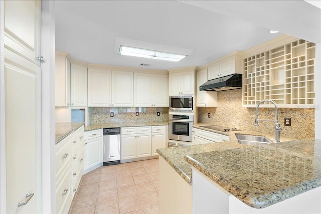 kitchen with kitchen peninsula, light stone countertops, tasteful backsplash, stainless steel appliances, and sink