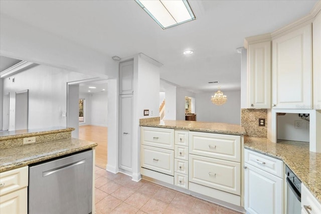 kitchen with kitchen peninsula, tasteful backsplash, dishwasher, hanging light fixtures, and light tile patterned flooring