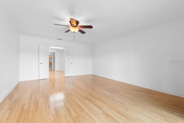 spare room featuring light hardwood / wood-style flooring, ceiling fan, and ornamental molding