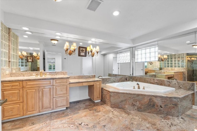 bathroom with a relaxing tiled tub and vanity