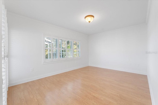 unfurnished room featuring light wood-type flooring and ornamental molding