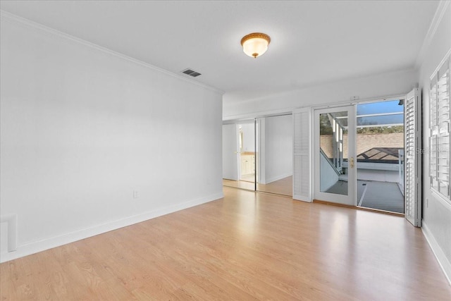 unfurnished room featuring crown molding and light hardwood / wood-style flooring