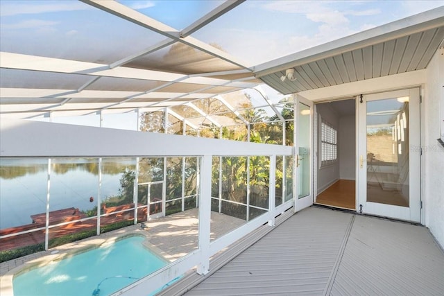 unfurnished sunroom with a water view and a wealth of natural light