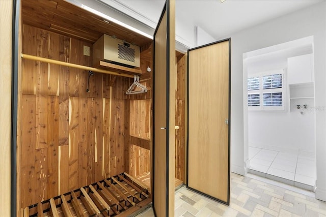 mudroom featuring wooden walls