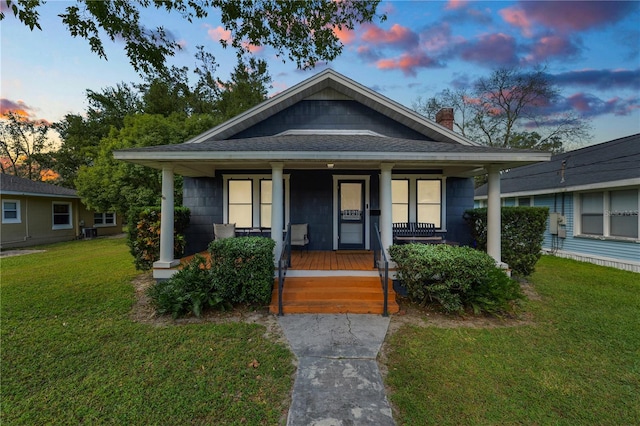 bungalow with a yard and covered porch