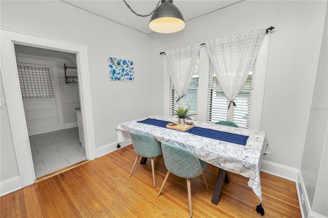 dining area featuring crown molding and wood-type flooring