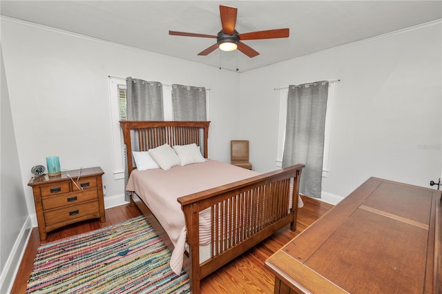 bedroom featuring ornamental molding, hardwood / wood-style floors, and ceiling fan