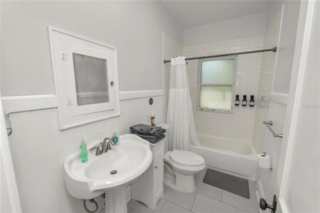 full bathroom featuring toilet, shower / bath combo, sink, and tile patterned flooring