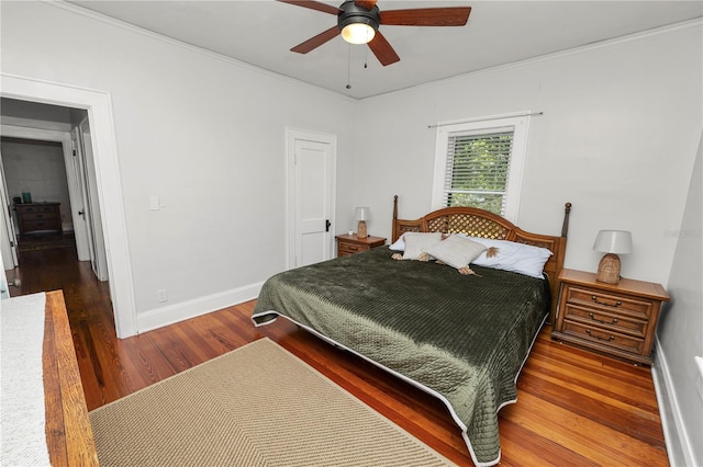 bedroom with ornamental molding, dark hardwood / wood-style floors, and ceiling fan