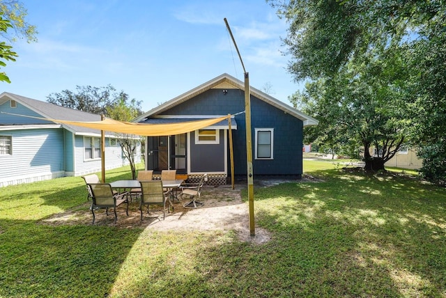 back of property with a patio and a lawn