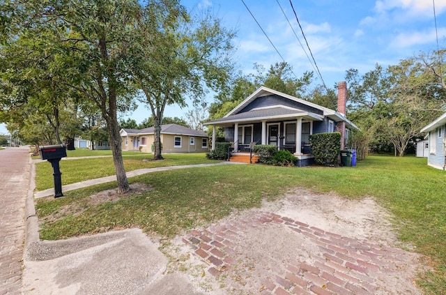 view of front facade with covered porch and a front yard