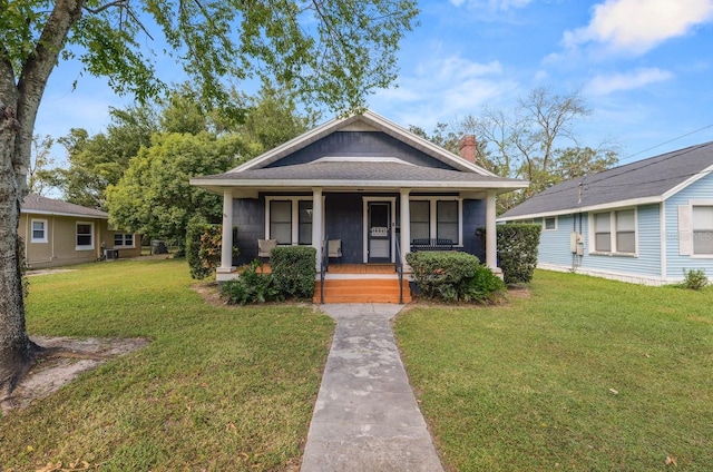 bungalow-style house featuring a front yard and covered porch