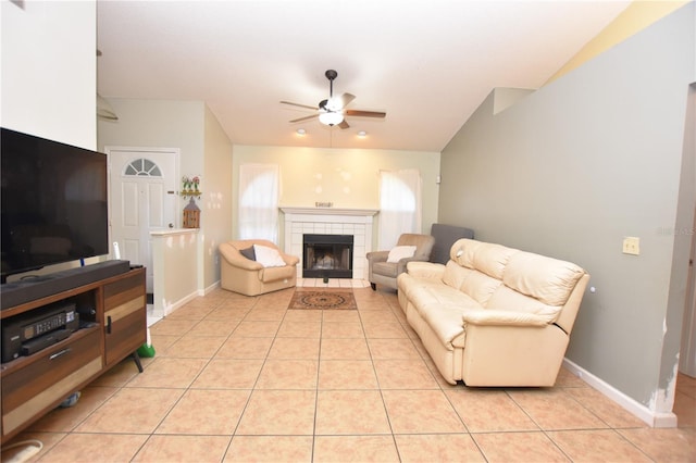 tiled living room featuring lofted ceiling, a tile fireplace, and ceiling fan