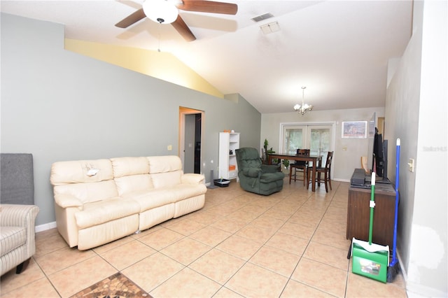 living room featuring light tile patterned floors, ceiling fan with notable chandelier, and vaulted ceiling