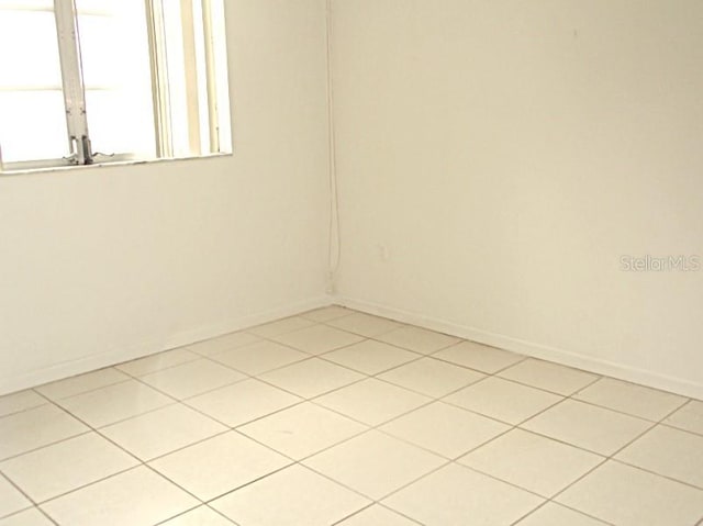 spare room with light tile patterned flooring