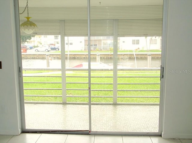 doorway to outside featuring light tile patterned floors and a healthy amount of sunlight