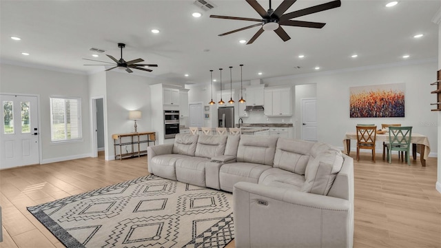 living room with ceiling fan, light hardwood / wood-style flooring, and ornamental molding