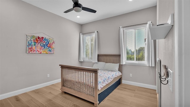 bedroom with light wood-type flooring and ceiling fan