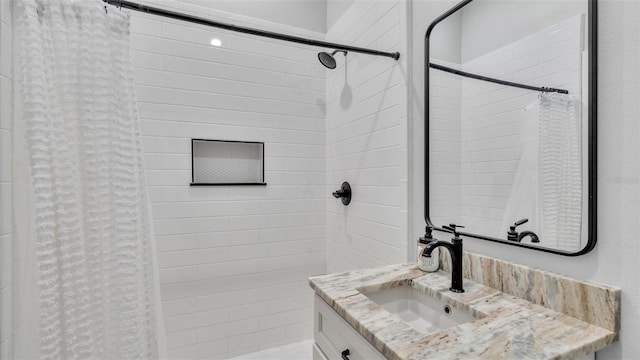 bathroom featuring vanity and curtained shower